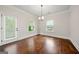 Dining room with hardwood floors, a door to the outside, modern lighting, and natural light from windows at 3865 Rifflepool Ct, Douglasville, GA 30135