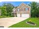 Charming two-story brick home with a well-manicured lawn and a spacious three-car garage at 3865 Rifflepool Ct, Douglasville, GA 30135