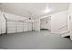 Spacious two car garage with white walls and a gray epoxy floor at 3865 Rifflepool Ct, Douglasville, GA 30135