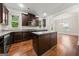 Modern kitchen featuring dark wood cabinets, granite countertops, and an island with a breakfast bar at 3865 Rifflepool Ct, Douglasville, GA 30135