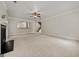 Spacious living room with white trim and walls, light carpet, fireplace, and view of stairs at 3865 Rifflepool Ct, Douglasville, GA 30135