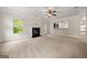 Spacious living room with white trim and walls, light carpet, fireplace, and large windows at 3865 Rifflepool Ct, Douglasville, GA 30135