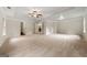 Large main bedroom with a ceiling fan, tray ceiling, and neutral carpeting at 3865 Rifflepool Ct, Douglasville, GA 30135