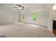Main bedroom with plush carpet, two windows, a ceiling fan, and tray ceiling at 3865 Rifflepool Ct, Douglasville, GA 30135