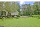 Backyard featuring green lawn, privacy fence, and mature trees at 1709 Reese Rd, Sharpsburg, GA 30277