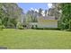 Well-kept backyard with lush lawn, trees, and privacy fence offering space for outdoor enjoyment at 1709 Reese Rd, Sharpsburg, GA 30277
