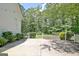 Outdoor patio with string lights overlooking a landscaped backyard and surrounding trees at 1709 Reese Rd, Sharpsburg, GA 30277