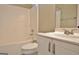 The bathroom has a white toilet, bathtub, shower, vanity, and natural light at 1709 Reese Rd, Sharpsburg, GA 30277