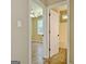 View of a bathroom and bedroom with hardwood floors and a white ceiling fan at 1709 Reese Rd, Sharpsburg, GA 30277