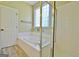 Bathroom featuring a large soaking tub with glass block window and separate glass shower at 1709 Reese Rd, Sharpsburg, GA 30277