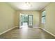 Bright bedroom with hardwood floors, ceiling fan, natural light and sliding doors to the backyard at 1709 Reese Rd, Sharpsburg, GA 30277