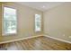 Cozy bedroom with wood-look floors, neutral walls, and ample natural light at 1709 Reese Rd, Sharpsburg, GA 30277
