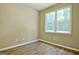 Bedroom with hardwood floors, one large window and neutral walls at 1709 Reese Rd, Sharpsburg, GA 30277