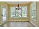 Breakfast nook features hardwood floors, big windows, and a modern chandelier at 1709 Reese Rd, Sharpsburg, GA 30277