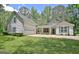 Charming two-story home features a well-maintained lawn, attached garage, and inviting curb appeal at 1709 Reese Rd, Sharpsburg, GA 30277