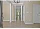 Bright foyer with modern wood-look floors, decorative columns, and neutral paint tones at 1709 Reese Rd, Sharpsburg, GA 30277
