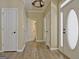 Well lit hallway with several doorways and hardwood floors at 1709 Reese Rd, Sharpsburg, GA 30277