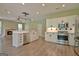 Open-concept kitchen featuring stainless steel appliances, white cabinets, and views to living area at 1709 Reese Rd, Sharpsburg, GA 30277