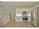 Spacious kitchen features stainless steel appliances, white cabinets, and modern backsplash at 1709 Reese Rd, Sharpsburg, GA 30277