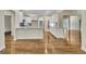 Open kitchen with white cabinetry, granite countertops, and hardwood floors at 1709 Reese Rd, Sharpsburg, GA 30277