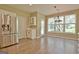 Cozy breakfast nook near the kitchen features stainless steel refrigerator and an exterior door at 1709 Reese Rd, Sharpsburg, GA 30277