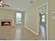 Living room features hardwood floors and a fireplace with a view into another bedroom at 1709 Reese Rd, Sharpsburg, GA 30277