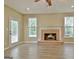 This living room is bright and airy, featuring hardwood floors and a brick fireplace at 1709 Reese Rd, Sharpsburg, GA 30277