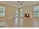 Living room with hardwood floors, brick fireplace, and plenty of natural light at 1709 Reese Rd, Sharpsburg, GA 30277