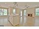 Open concept living room with an island, brick fireplace, hardwood floors, and plenty of natural light at 1709 Reese Rd, Sharpsburg, GA 30277
