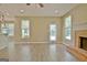Spacious living room features hardwood floors, fireplace, and glass door for lots of natural light at 1709 Reese Rd, Sharpsburg, GA 30277