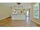 Living room has hardwood floors and a breakfast bar with hanging light fixtures at 1709 Reese Rd, Sharpsburg, GA 30277