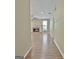 Hallway view of the living room with a traditional fireplace and hardwood floors at 1709 Reese Rd, Sharpsburg, GA 30277