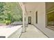 Covered porch featuring white columns and a door leading to backyard at 1709 Reese Rd, Sharpsburg, GA 30277