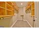 Well-organized walk-in closet with custom wooden shelving and hanging rods at 1709 Reese Rd, Sharpsburg, GA 30277
