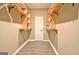 Walk-in closet with custom wood shelving for folded clothing and storage at 1709 Reese Rd, Sharpsburg, GA 30277