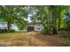 Large backyard featuring a screened porch and mature trees, perfect for outdoor enjoyment at 1875 Tree Brooke Ln, Snellville, GA 30078