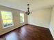 Bright dining room with hardwood flooring, a stylish chandelier, and large windows at 1875 Tree Brooke Ln, Snellville, GA 30078