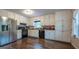 The kitchen offers stainless steel appliances, white cabinets, and beautiful hardwood floors at 1875 Tree Brooke Ln, Snellville, GA 30078