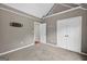 Bedroom featuring soft carpeting, an open doorway, and a spacious closet for ample storage at 65 Pecan Ln, Oxford, GA 30054