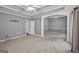 Spacious bedroom with carpet flooring, a ceiling fan, archway to another room, and decorative ceilings at 65 Pecan Ln, Oxford, GA 30054