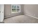 Bedroom with plush carpeting and a bright window at 65 Pecan Ln, Oxford, GA 30054