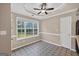 Bright dining area featuring unique tile flooring, a ceiling fan, and a large window with natural light at 65 Pecan Ln, Oxford, GA 30054