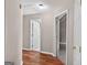 Hallway with hardwood flooring leading to doorways, providing seamless transitions between rooms at 65 Pecan Ln, Oxford, GA 30054