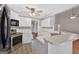 Modern kitchen showcasing white cabinets, a breakfast bar, and stainless steel appliances, offering a stylish and functional space at 65 Pecan Ln, Oxford, GA 30054