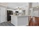 Open kitchen features a breakfast bar, modern appliances, and seamless flow into the living area, ideal for entertaining guests at 65 Pecan Ln, Oxford, GA 30054