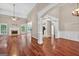 Spacious living room featuring hardwood floors, a cozy fireplace, and abundant natural light streaming through large windows at 65 Pecan Ln, Oxford, GA 30054