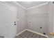 This mud room features striking tile flooring and includes a metal shelving unit at 65 Pecan Ln, Oxford, GA 30054
