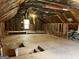 Unfinished attic space with exposed insulation, ductwork, flooring and natural light from a window at 807 Oak Bridge Ln, Fayetteville, GA 30214