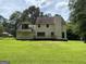 Spacious backyard featuring a deck and lush green lawn surrounded by mature trees at 807 Oak Bridge Ln, Fayetteville, GA 30214