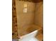 Bathroom featuring bathtub with marble-look tile and decorative wallpaper at 807 Oak Bridge Ln, Fayetteville, GA 30214